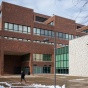 North Campus with snow after a storm in November 2022. The clock installed outside One World Cafe on Norton Hall with Capen Hall behind. Photographer: Douglas Levere. 