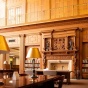 Photo of person standing in library looking at books. 