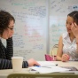Image of learning designing assisting faculty member. 