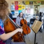 Jonathan Golove, with the department of music, teaches a student in a one-on-one cello lesson in an office space in Baird Hall in September 2023. 