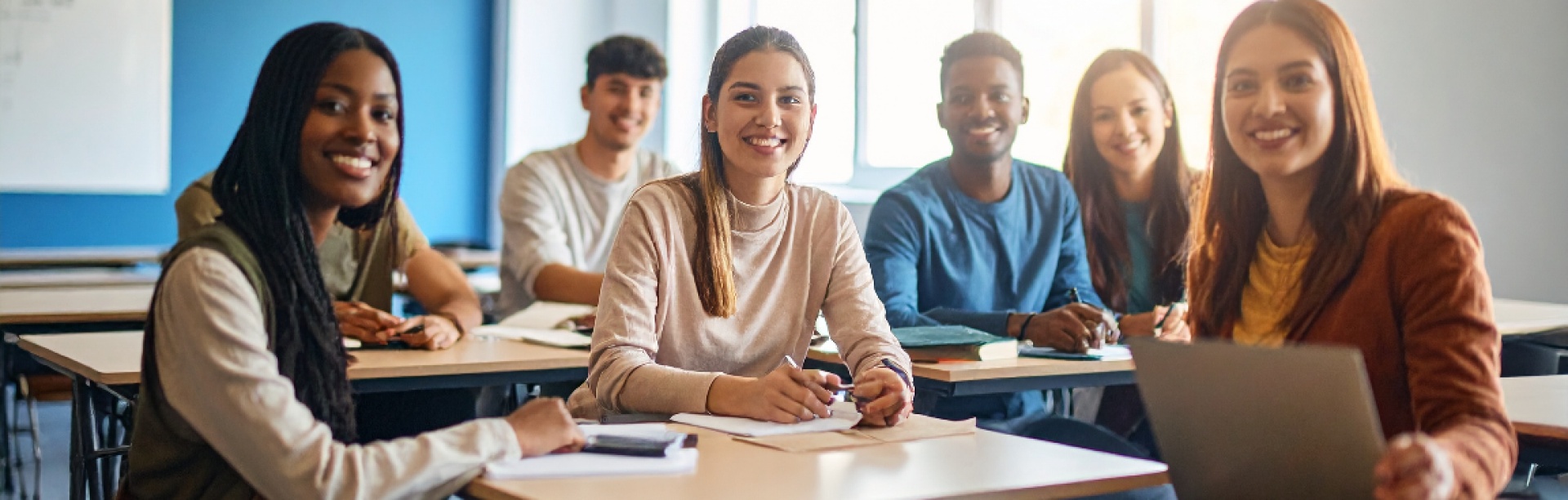 A group of diverse students in a classroom. 