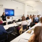 Students sitting in a large lecture hall. 