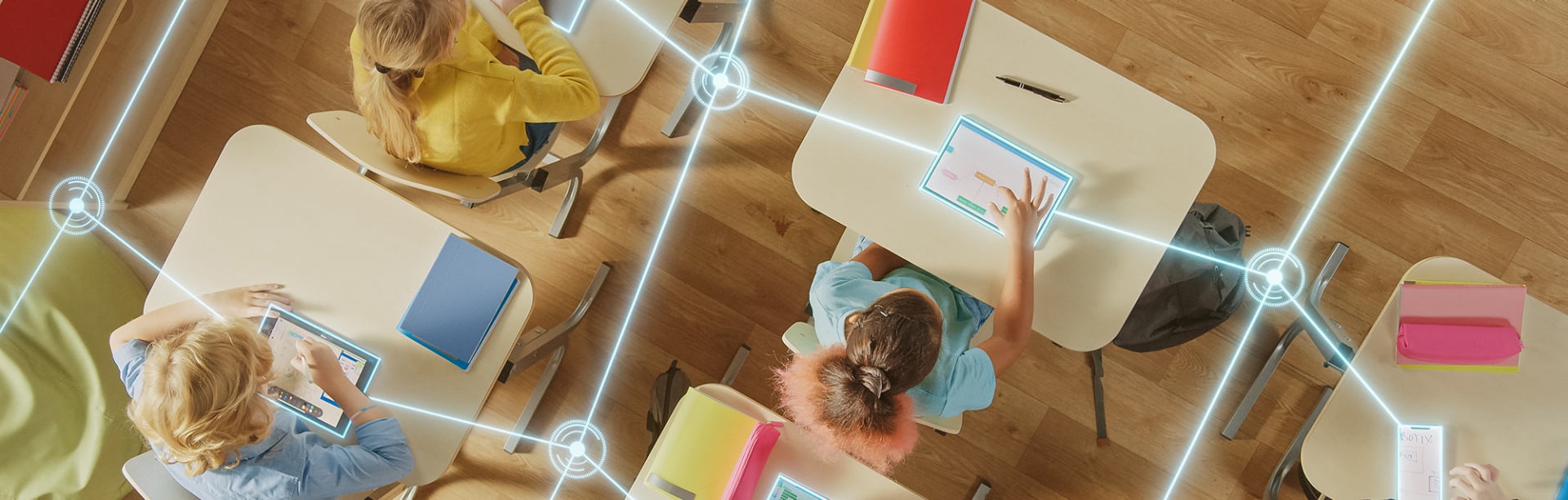 Students in a classroom with their devices interconnected by AI.