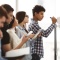 College students working on a white board. 