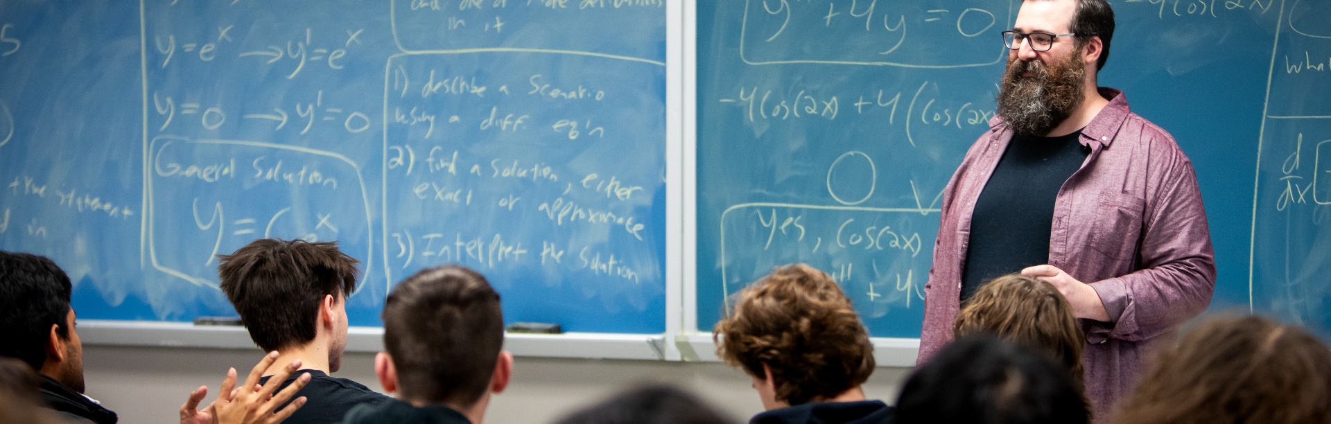 Corey Placito shares a lecture in a classroom full of students.