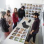 Randy Fernando (right), with architecture and planning, meets with students in his class Integrating Generative AI for Architectural Excellence in Crosby Hall in February 2024. 