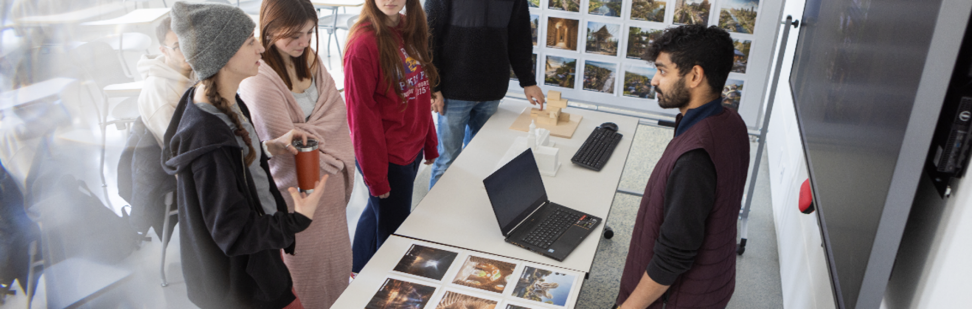 Randy Fernando (right), with architecture and planning, meets with students in his class Integrating Generative AI for Architectural Excellence in Crosby Hall in February 2024.