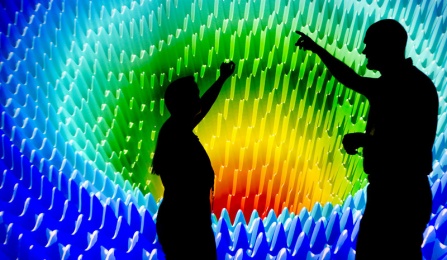 Groundwater Modeling Visualization on large screen with two people shadowed in front of it. 