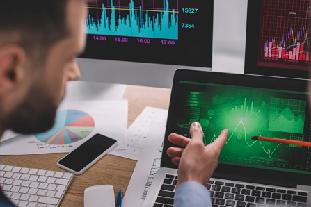 Two people looking at data on a laptop doing analysis. 