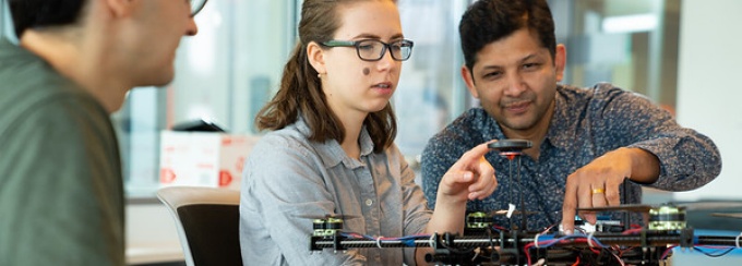 faculty and students working on a drone. 