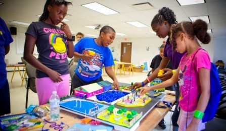 Kids interacting with a diorama.