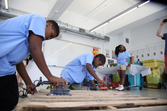 Students sanding wood. 