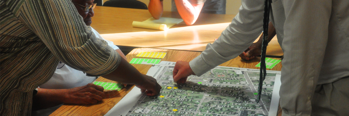 Hands touching a neighborhood map. 