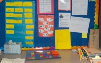 Zoom image: Tutoring carrel of a second grader. The clinicians and child spend time every tutoring session solidifying his knowledge of common ending sounds and letters. 