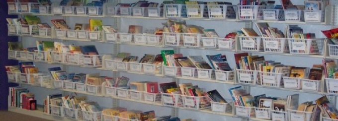 Zoom image: Children can check out books from the CLaRI library to read at home. 