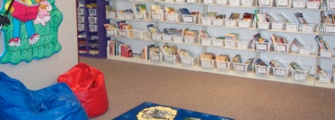 Zoom image: Kids enjoy sitting in the beanbag chairs and reading a book from the CLaRI library. 