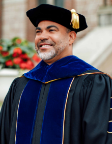 A man in full PhD academic regalia. 