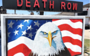A sign with an eagle's head and a flag behind it. Above the Eagle, it says Death Row. 