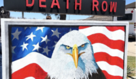 A sign with an eagle's head and a flag behind it. Above the Eagle, it says Death Row. 