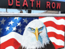 An image of a sign featuring an eagle's head with the American flag in the background and above it the sign says Death Row. 