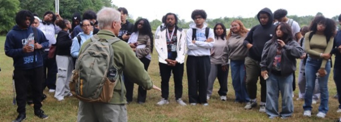 Professor teaching to a group of EOp students in an outside setting. 