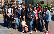 Groups of students standing outside. 