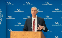 Photo of retired CTSI Director Timothy Murphy, MD, at a podium during a press conference at the Jacobs School. 