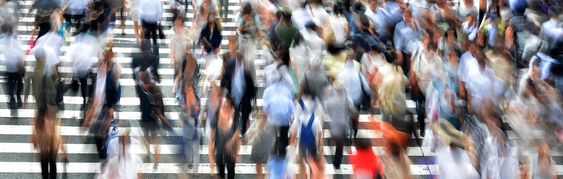 Blurred photo of people rushing every which way on outdoor steps. 