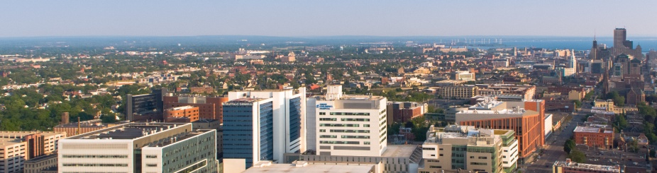 Photo of the skyline of the Buffalo Niagara Medical Campus, with the Clinical and Translational Research Center prominent on the left side and the Jacobs School visible on the right. 