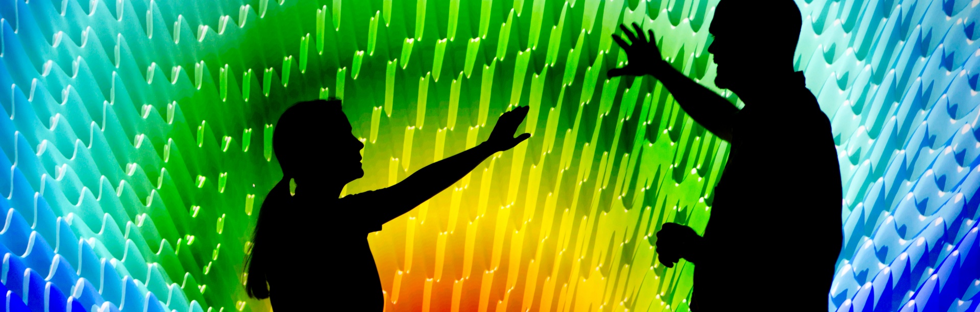 A young woman and a man point toward a large, multicolored visual. Text reads: Biostatistics, Epidemiology, and Research Design BERD: Collaborative and education resources for study design and statistical analysis. 