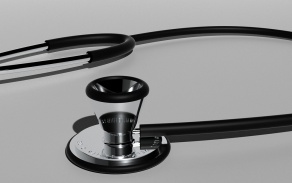 Photo of a stethoscope on a shiny table. 
