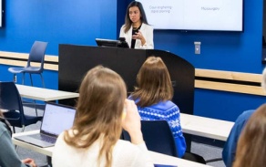 Photo of a presentation at UB's North Campus watched by rows of students. 