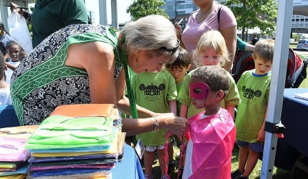 Photo of a woman helping a small child at Canalside in Buffalo. 