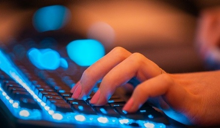 hands on a computer keyboard. 