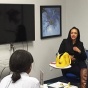 A female entrepreneur speaks to students inside the Blackstone LaunchPad office. 