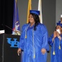 Person on stage with cap and gown. 