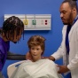 Certified Nurse Assistant assisting a patient. 