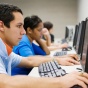 Group of people looking at computer screens. 