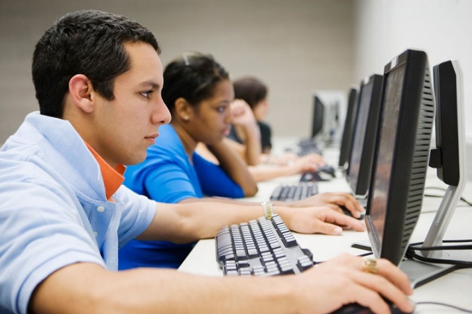 Group of people looking at computer screens. 