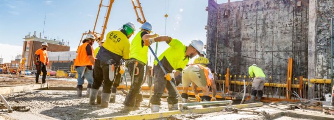 Construction workers on a concrete form. 