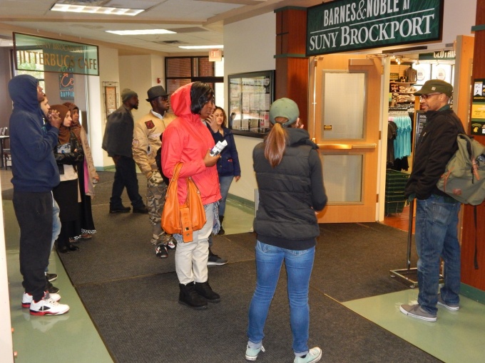 People standing outside of a college bookstore. 
