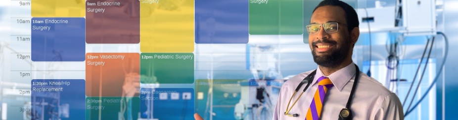 A man with glasses is smiling in a lab setting. 