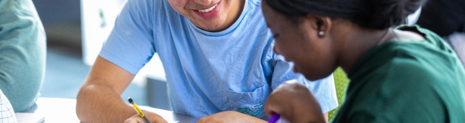 Two students reviewing a paper. 