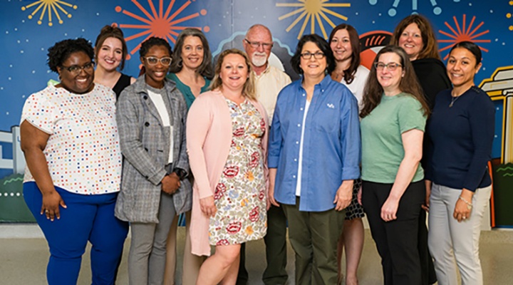 Exploratory and Pre-Professional Advising Center staff standing for picture and looking at camera in Capen Hall. 