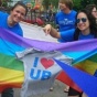Students with a rainbow flag and "I Love UB" shirt. 