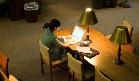 Student studying in a library. 