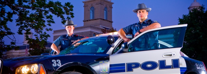 Two University Police Officers and a police cruiser. 