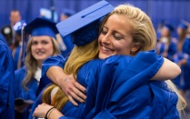Graduates hugging. 