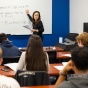 A faculty member presents to a group of students. 