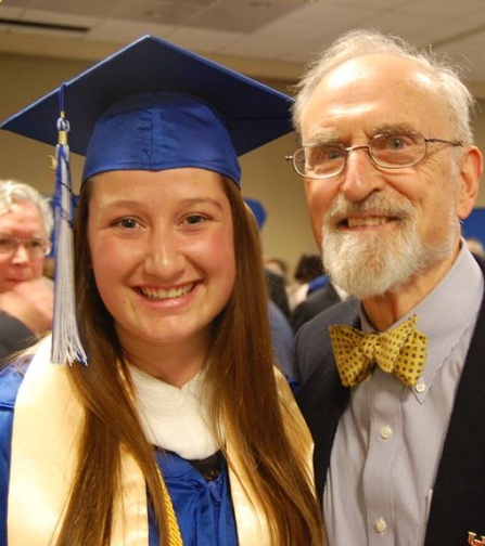 Courtney Burroughs wearing a graduation cap and gown and Claude Welch. 